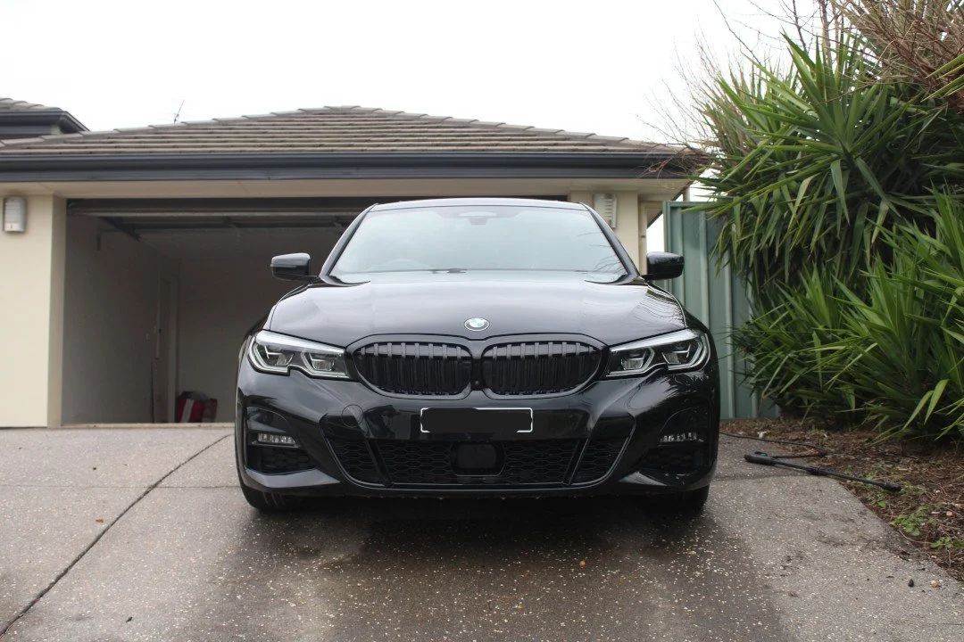 Paint correction in progress on a dark vehicle